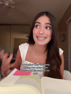 A young woman with long brown hair and braces is the focus. She is seated and slightly angled, with a soft background showing an interior room possibly representing a bedroom. She has an open book in front of her. Text overlaying the image explains the context of her words about friendship.