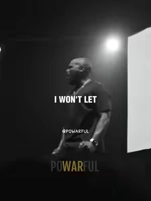 A black and white image shows a man in a dark setting, possibly on a stage or in a studio. The man, viewed from the side, is wearing a dark shirt and has short hair. Text overlays read 'I WON'T LET' and '@POWARFUL' and the word 'POWARFUL' appears below.