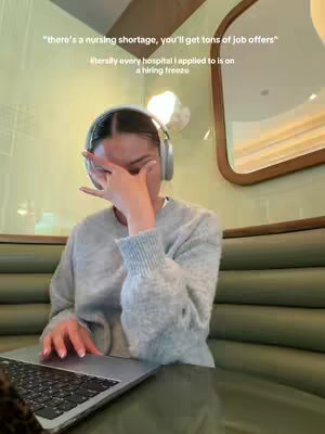 A young woman wearing headphones sits in a booth, resting her hand on her forehead and covering her eyes in a gesture of frustration or fatigue. A laptop sits in front of her on the table. Text overlays the image with quotes about nursing.