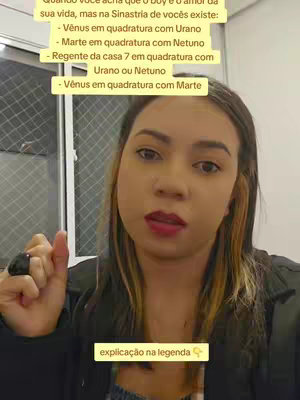 A woman with light skin, brown hair, and red lipstick is in a selfie-style shot, angled slightly upward. She points with her right index finger. Text overlays appear in yellow rectangles at the top and bottom of the frame, in front of an interior background. Various text elements are in the background.