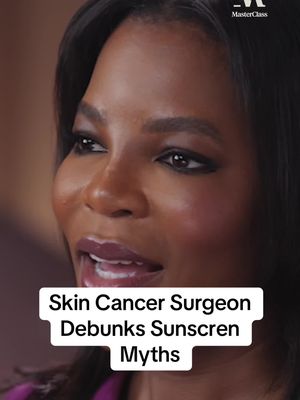 The cover image features a close-up of a woman with dark skin, looking slightly to the side with a partially open mouth, suggesting she is speaking. She has neatly styled black hair and is wearing makeup, including dark eyeliner and a deep lip color. Below her, a white rectangular overlay contains the text, 'Skin Cancer Surgeon Debunks Sunscreen Myths'. The background is a blurred, neutral tone.