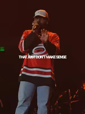A man wearing a red and black jersey and a hat, holding a microphone and gesturing with his hand. Text overlayed on the image reads: THAT JUST DON'T MAKE SENSE.