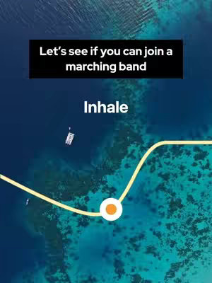 An overhead shot of a body of water, likely the ocean. The water is a deep blue near the bottom and lightens to a turquoise color nearer the surface. Small white boat is visible. A yellow line with a white circle is overlaid near the bottom of the image.