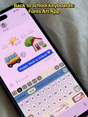 A smartphone screen displaying a customized keyboard with a bubbly, pastel aesthetic. The phone shows a texting interface. The background of the screen is a light pink. The keyboard itself is visible at the bottom, with a variety of aesthetic fonts selected. Above the keyboard, there is a preview of a text conversation with multiple emoji