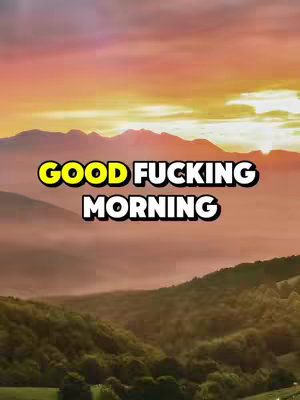 The cover image displays a scenic vista, likely captured at sunrise or sunset. The foreground is dominated by rolling green hills and valleys, with indistinct trees adding texture to the landscape. A layer of fog or mist partially obscures the mid-ground, creating atmospheric depth. Above this, a range of mountains stretches across the frame, silhouetted against a vibrant sky. The sky transitions from warm yellows and oranges near the horizon to a softer pink and purple higher up. The overall impression is one of tranquility and natural beauty.