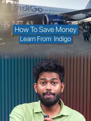 The cover image shows a man in the bottom half of the frame, with an airplane visible in the background. The man is looking at the camera, he appears to be inside or near the airport, with an Indigo plane and people near the airplane. The text "How To Save Money Learn From Indigo" is displayed in a blue text overlaid on the image.