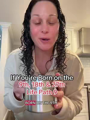 A woman with wet, dark, curly hair is looking at the camera and speaking with a smile. She is holding a metal mug. The overlay text has a black background with white text that reads 'If You're Born on the 9th, 18th & 27th Life Path 9 BORN ON THE 9TH'.