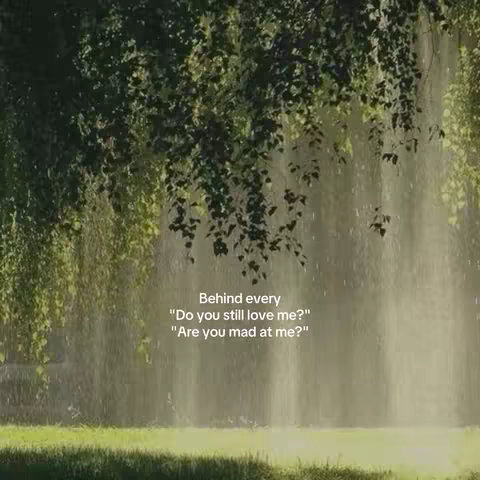 The image depicts a natural scene with a focus on trees, grass, and rain. Overhanging branches create a canopy, with light filtering through the leaves and falling as gentle rain. Below, green grass provides a base for the scene. Text is overlaid on the image, posing questions like "Do you still love me?" and "Are you mad at me?"