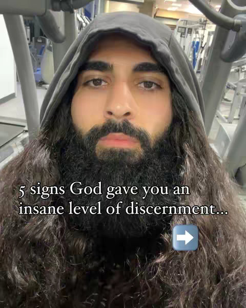 The cover image features a close-up of a man with a long beard and long hair, wearing a dark hoodie. Text overlays includes the phrase: '5 signs God gave you an insane level of discernment...'