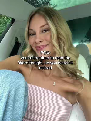 The video cover shows a woman in a car, looking at the camera with a slight smile. She's wearing a white and pink striped strapless top and a necklace. The background is soft focus, suggesting the car's interior and some greenery outside.