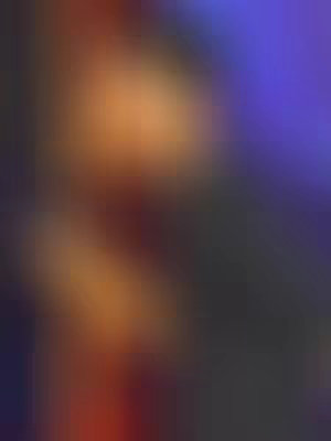 Abstract artwork with a blurred background and layered colors. There are reddish-orange and dark gray shades in the composition.