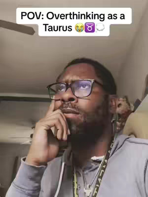 A man with glasses looking up, resting his finger on his mouth. Text overlay reads 'POV: Overthinking as a Taurus' with related emoji.