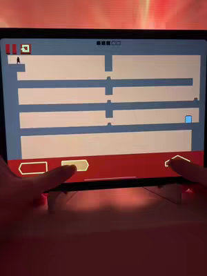An iPad screen displaying a level of the mobile game Level Devil, with the player's hands interacting with the game's controls. The screen shows a side-scrolling platform layout with a small black figure representing the player.
