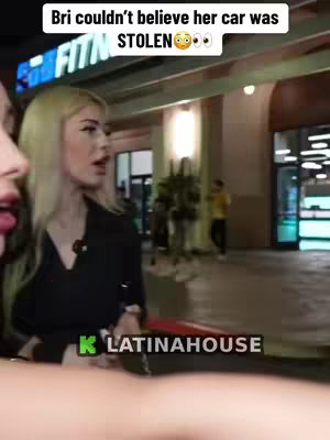 The cover image shows a woman with blonde hair in front of a building. The foreground shows another woman's face on the left. The background has text and a logo.