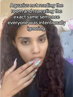 A close-up shot of a woman, framing her face. She has long, dark wavy hair and is looking towards the bottom right. Her left hand is raised, with fingers partially covering her lips. Her fingernails are long and painted with colorful designs. Above her is overlaid text.