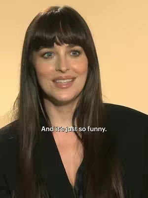 The cover image features a close-up of a woman with long, dark hair and bangs, centered in the frame. She has a soft smile and is looking slightly off-center. The background is a solid, warm yellow color. Text overlayed on the image reads, "And it's just so funny."