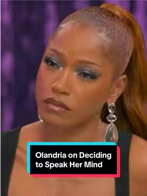 The cover image features a close-up of a woman with a serious expression. The woman, with a medium skin tone, is seen from the shoulders up. She has medium-length, dark hair pulled back into a ponytail, and wears dangling earrings. Her prominent makeup includes blue eyeshadow and a dark lip color. The background is a blurred purple setting. A text overlay in a rectangle at the bottom of the image says: "Olandria on Deciding to Speak Her Mind".