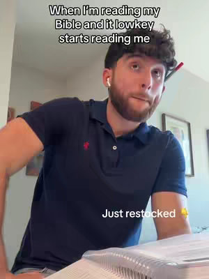 The cover image is a selfie-style shot featuring a young man with a beard, dark hair, and wearing a dark blue polo shirt. He is positioned slightly off-center, with the upper half of his body visible. The background shows a room with a wall, pictures and the edge of a notebook. The lighting appears natural, and the overall composition is informal and personal, suited for a video.