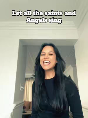 A woman with long, dark hair stands in a doorway, smiling, with the text overlayed at the top. The background is a beige hallway with a glimpse of a living room. The overall composition is bright and natural, with the woman in the foreground.