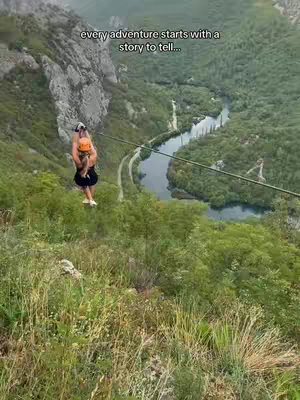The cover image showcases a woman mid-zip line over a lush, green valley with a river winding through. The woman is seen from behind, wearing a dark outfit and an orange helmet. Text overlays are placed at the top.
