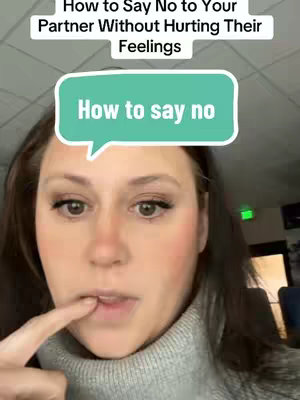 A woman with brown hair is shown from the chest up, facing the camera. She is wearing a grey turtleneck sweater and has one finger touching her lip. In the upper portion of the image, text appears, and a speech bubble overlay with text is in the center. The background is out of focus revealing an interior setting.