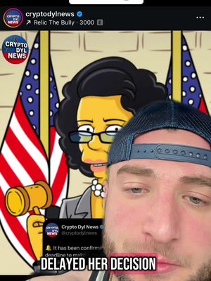 The cover image is a split view. On the right side, a man with a beard and a blue cap looks at the camera. On the left, a cartoon image of a woman behind the American flag; a person from 'The Simpsons' is in the background with a gavel and text. Overlayed text in pink against a black rectangle reads 'DELAYED HER DECISION'.