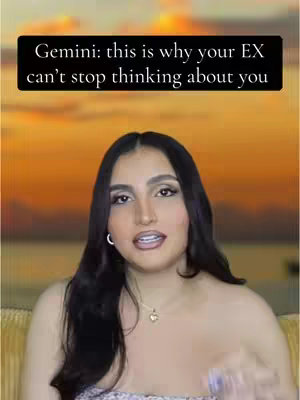 A woman with dark hair and makeup looks at the camera. Behind her is an orange sunset background.