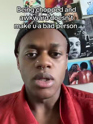 A close-up shot featuring a person of color with short hair, a black beanie, and a red collared shirt. The person has a septum piercing and looks directly into the camera with a neutral expression. Behind them, a collage of various images is visible, creating a textured background. The text overlay reads, "Being chopped and awkward doesn’t make u a bad person."