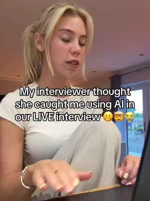 A young woman with blonde hair is sitting in front of an unseen screen, appearing to be in an interview. Text overlays state a person thought she was using AI. The setting appears to be a casual indoor space.