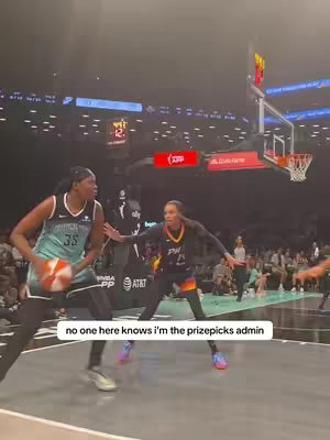 A cover image of a basketball game with two female players in action. The scene is indoors with an audience in the background. Text overlay indicating that the creator is the prize picks admin.