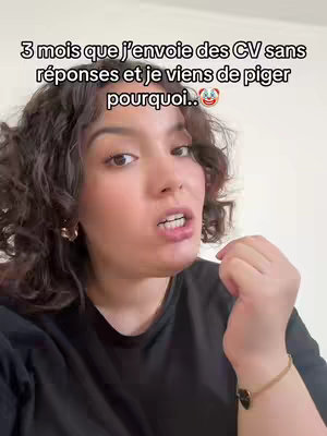 A selfie-style shot of a woman looking directly at the camera and speaking. She is wearing a black top and has curly, dark hair. Text overlays explain why she has been having a tough time getting her CV's accepted.
