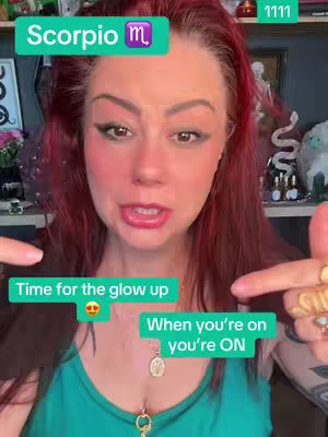 The cover image features a fair-skinned woman with red hair and vibrant makeup, set against a cluttered, colorful background. The woman, who looks directly at the camera, is making a talking motion. In the top left corner, there is a green box with the text "Scorpio m". Below, two green boxes display the phrases Time for the glow up, and When you're on you're ON. The background includes various decorations, and the lighting suggests an indoor setting.