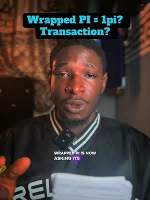A man with dark skin is centered in front of a blurry indoor background, likely a room. He's wearing a black shirt with a white collar, and a small microphone is clipped to his collar. Text overlays appear above and below him.