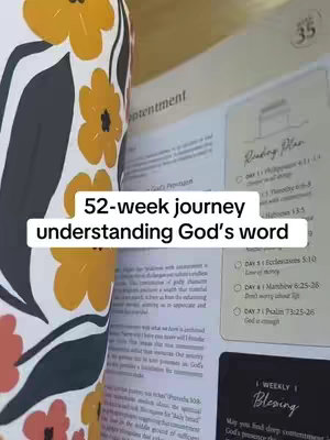 The image shows an open book with floral designs. The text overlay reads '52-week journey understanding God's word'. There's a reading plan and weekly blessings noted.