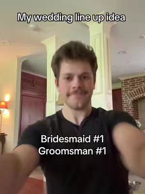 A selfie-style shot with a man in a black shirt in the foreground. The background shows a brightly lit indoor space, possibly a home interior, with white trim and a red door or panel visible. Text overlays are added to the cover image.