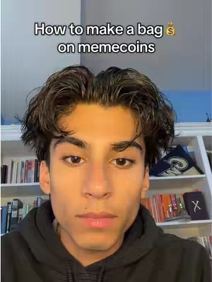 A young man with dark hair and a black hoodie is centered in the frame. Above him, white text reads, 'How to make a bag on memecoins' followed by a money bag emoji. Bookshelves and a white cabinet are slightly visible in the background.
