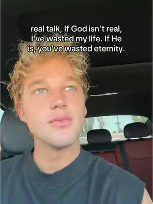 A young man with blond hair and blue eyes is centered in the frame, looking upward with a thoughtful expression. Text overlayed on the top states a philosophical question about faith. The background shows the inside of a car with the steering wheel out of frame to the top right.