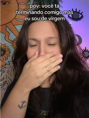 A young woman with long brown hair and a tattoo on her left arm is covering her mouth with her right hand in a surprised or emotional gesture. The background includes a patterned wall on the left side. Text overlay is present at the top.
