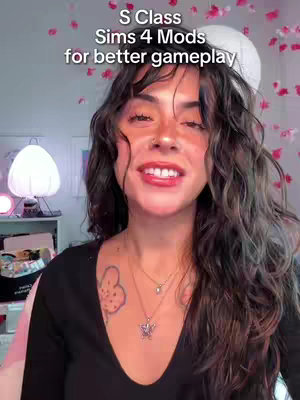 The cover image shows a woman with long, dark hair, a nose ring, and a tattoo on her chest. She is smiling at the camera. Text overlays read, "S Class Sims 4 Mods for better gameplay". The background is softly lit, with pink flower-like shapes.