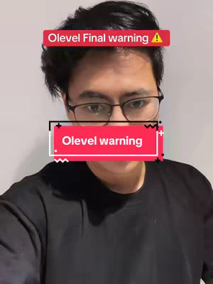 A young man with glasses is central in the image, framed from the chest up. Above his head, a red banner states "Olevel Final warning" with an exclamation mark, while another banner, also red and white, obscures his mouth, displaying "Olevel warning". He's wearing a black shirt, and the background is a plain white wall.