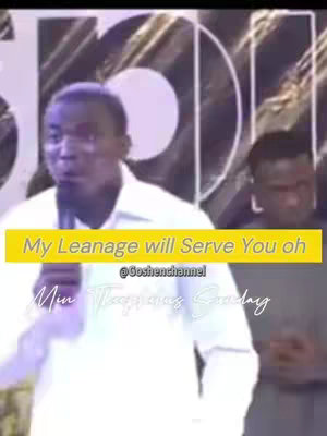 The cover image is a medium shot of a Black man speaking into a microphone on a stage. He is wearing a white collared shirt. Behind him, there is another person partially visible on the right, out of focus. A yellow box with text written on it overlayed on top of the image.