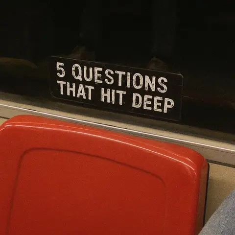 The image shows a close-up of a red seat on public transport, with a sign above it saying '5 QUESTIONS THAT HIT DEEP', in white text on a black background.