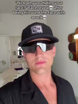 A man wearing sunglasses and a black cap in a bright setting, with the text overlayed at the top.