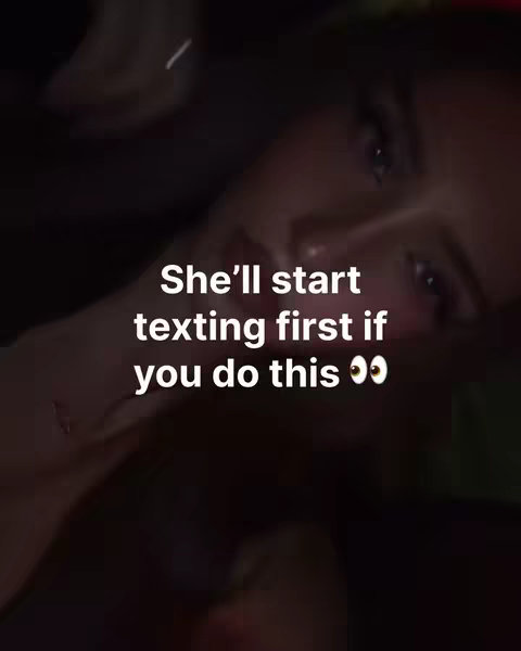 A dimly lit photo of a woman facing towards the camera, with a text overlay. The woman's face is partially visible, with soft lighting highlighting her features. The text overlay is centered and in white, suggesting a relationship context, and uses two eye emojis to emphasize the message. The background has a blurry effect.