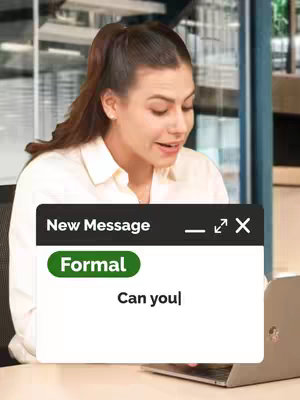 A woman with her hair in a high ponytail sits at a desk with a laptop, looking towards the screen. A mock-up of a message box is overlaid on the lower portion of the image with the word "Formal" in a green colored bubble, along with the words "Can you|" in the box, implying this is a lesson on formal English phrases. Behind her is an office setting.
