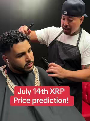 An image shows two men, one getting a haircut from the other. The man getting the haircut is in the foreground, with a partially shaved head, a gold chain, and white earbuds. The barber, in the background, cuts the man's hair with scissors.