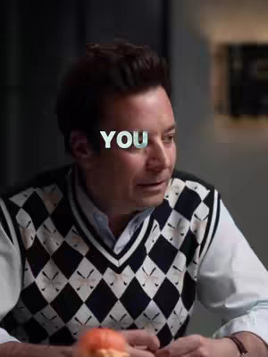 A man wearing a diamond pattern sweater vest positioned in front of an undetailed blurry background. The text 'YOU' is overlaid on the image.