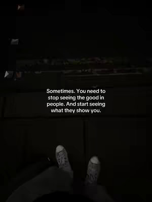 The cover image is a vertically oriented shot, likely a selfie, taken in a dim setting. The main focus is on a person's feet, clad in casual sneakers with a repeating design. The background appears blurry, suggesting the shot was taken indoors or in a low-light environment. Overlaying the image is white text, which states a reflective quote about seeing the truth in people, encouraging viewers to look beyond initial impressions.