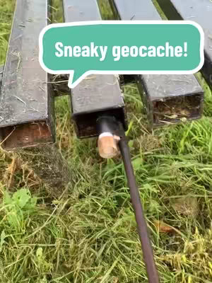 The image shows a close-up of a geotag holder with a small opening where the geotag has been placed. There is a speech bubble overlay that contains text on the geotag's hiding spot.