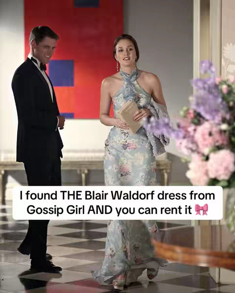 The image depicts a scene from the TV show, Gossip Girl. A woman in a floral dress and a man in a tuxedo are standing in a well-lit room. Text overlayed on the bottom of the image advertises renting the dress.